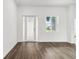 Bright foyer with wood-look floors and a view of the front door and window at 4160 Belladonna Ave, North Port, FL 34286