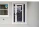Modern front door with glass panels providing natural light, alongside a window at 4160 Belladonna Ave, North Port, FL 34286