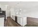 Kitchen with stainless steel appliances, a center island with seating, and wood-look floors at 4160 Belladonna Ave, North Port, FL 34286