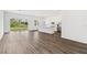 Bright, open-concept living space with wood-look floors adjacent to the kitchen at 4160 Belladonna Ave, North Port, FL 34286