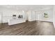 Open concept living space with wood-look floors, adjacent to modern kitchen with island at 4160 Belladonna Ave, North Port, FL 34286