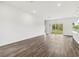 Open concept living room with wood-look floors, recessed lighting, and access to the backyard at 4160 Belladonna Ave, North Port, FL 34286