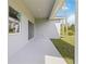 Covered patio with sliding glass door and grassy backyard at 4160 Belladonna Ave, North Port, FL 34286