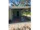 Charming covered front entrance with paved patio and security cameras at 15008 Spokane Rd, Spring Hill, FL 34610
