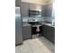 Grey kitchen with stainless steel appliances, granite countertops, and tile backsplash at 15008 Spokane Rd, Spring Hill, FL 34610