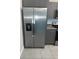 Stainless steel refrigerator with water dispenser and grey cabinets at 15008 Spokane Rd, Spring Hill, FL 34610
