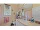Bright bathroom with a single vanity, large mirror, and decorative curtains at 18011 Prairie Wolf Gln, Parrish, FL 34219