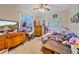 This bedroom features a ceiling fan and a large window with a Frozen curtain at 18011 Prairie Wolf Gln, Parrish, FL 34219