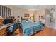 This bedroom features a ceiling fan and a bed with blue bedding at 18011 Prairie Wolf Gln, Parrish, FL 34219