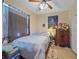 Neutral bedroom with ample natural light, a bed, dresser, and closet for convenient living at 18011 Prairie Wolf Gln, Parrish, FL 34219