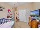Bedroom with a TV, dresser, and closet, offering a simple yet usable space at 18011 Prairie Wolf Gln, Parrish, FL 34219