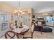 Charming dining area featuring chandelier lighting, a round table, and living space views at 18011 Prairie Wolf Gln, Parrish, FL 34219