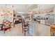 Open concept kitchen features white cabinets, tile floors and an island with barstool seating at 18011 Prairie Wolf Gln, Parrish, FL 34219