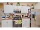 A detailed kitchen with white cabinets, stainless steel appliances, and ample counter space at 18011 Prairie Wolf Gln, Parrish, FL 34219