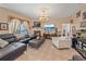 Comfortable living room featuring tile floors, dark leather furniture, and a fireplace at 18011 Prairie Wolf Gln, Parrish, FL 34219