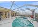 Relaxing screened-in pool with spa, surrounded by a spacious patio and lush landscaping at 18011 Prairie Wolf Gln, Parrish, FL 34219
