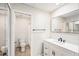 A clean bathroom features a modern vanity, toilet, and tiled shower at 1961 Whitney Way, Clearwater, FL 33760