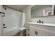 A clean bathroom features a new vanity, toilet, and tiled shower and tub at 1961 Whitney Way, Clearwater, FL 33760