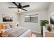 The main bedroom features a queen-sized bed, neutral tones, and a ceiling fan at 1961 Whitney Way, Clearwater, FL 33760