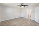 An empty bedroom has light gray walls and tile flooring at 1961 Whitney Way, Clearwater, FL 33760