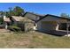 Exterior view of the home with a side carport and lush, mature landscaping at 1961 Whitney Way, Clearwater, FL 33760