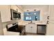 Bright kitchen with stainless steel appliances, white cabinets, and quartz countertops at 1961 Whitney Way, Clearwater, FL 33760