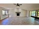 Spacious living room with tile flooring, a decorative fireplace, and sliding doors at 1961 Whitney Way, Clearwater, FL 33760
