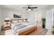 The primary bedroom features a queen-sized bed, neutral tones, and a ceiling fan at 1961 Whitney Way, Clearwater, FL 33760