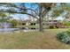 A beautiful pond with a fountain and a bridge with the home in the background at 1961 Whitney Way, Clearwater, FL 33760