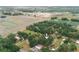 This property boasts an aerial view showcasing the home surrounded by trees, near open land, and a developing residential area at 2804 Robinson Rd, Plant City, FL 33565