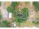 This property boasts an aerial view showing the home nestled among lush trees and the layout of the surrounding neighborhood at 2804 Robinson Rd, Plant City, FL 33565