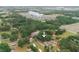 This property boasts an elevated perspective showing the home in a leafy area with distant views of a large building and parking at 2804 Robinson Rd, Plant City, FL 33565