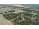This property boasts a bird's-eye view, showing the home's setting amidst a mix of trees, roads, and nearby buildings at 2804 Robinson Rd, Plant City, FL 33565
