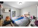 Bright bedroom featuring modern decor, a window and wood-look floors at 2804 Robinson Rd, Plant City, FL 33565