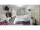 Cozy bedroom with gray floors, TV, and unique wicker headboard at 2804 Robinson Rd, Plant City, FL 33565