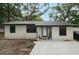 Charming single-story home featuring a metal roof, neutral paint, and minimalist landscaping at 2804 Robinson Rd, Plant City, FL 33565
