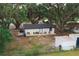 This property boasts a charming white home with a black roof, spacious backyard, and an inviting outdoor seating area at 2804 Robinson Rd, Plant City, FL 33565