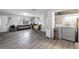 Open-plan living room and laundry area with wood-look floors, neutral walls, and modern appliances at 2804 Robinson Rd, Plant City, FL 33565