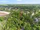 Aerial view shows the home in its natural environment, surrounded by lush greenery and mature trees with a pin-drop at 6005 Ike Smith Rd, Plant City, FL 33565