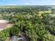Expansive aerial view of a property surrounded by lush greenery and trees at 6005 Ike Smith Rd, Plant City, FL 33565