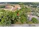 Aerial view showing the home's location, surrounded by lush greenery and mature trees with a pin-drop for location at 6005 Ike Smith Rd, Plant City, FL 33565