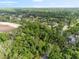 Aerial view showcasing home's location amongst lush greenery, mature trees, and beautiful natural surroundings, marked by pin-drop at 6005 Ike Smith Rd, Plant City, FL 33565