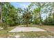 A concrete slab sits in a grassy backyard at 6005 Ike Smith Rd, Plant City, FL 33565