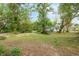 A wooded backyard with a view of home in the distance at 6005 Ike Smith Rd, Plant City, FL 33565