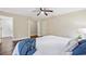 Bedroom boasts wood floors, a ceiling fan, and access to an en-suite bathroom and closet at 6005 Ike Smith Rd, Plant City, FL 33565