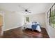 Bright bedroom with wood floors, a ceiling fan, and great natural light from the windows at 6005 Ike Smith Rd, Plant City, FL 33565