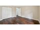 Bedroom with wood floors, a double closet, and natural light at 6005 Ike Smith Rd, Plant City, FL 33565