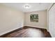 Well-lit bedroom features wood floors, a large window, and a double door closet at 6005 Ike Smith Rd, Plant City, FL 33565