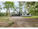 Exterior view of a house with screen porch and green surroundings at 6005 Ike Smith Rd, Plant City, FL 33565