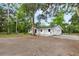 Exterior view of a cozy home featuring a well-manicured lawn and private driveway at 6005 Ike Smith Rd, Plant City, FL 33565